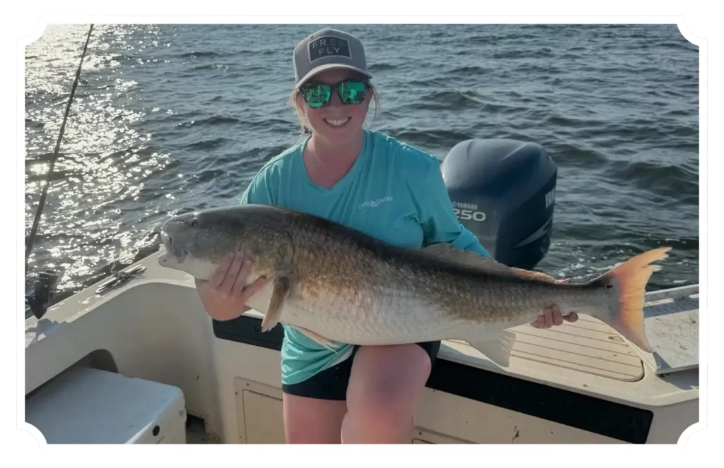 holding a fish on boat